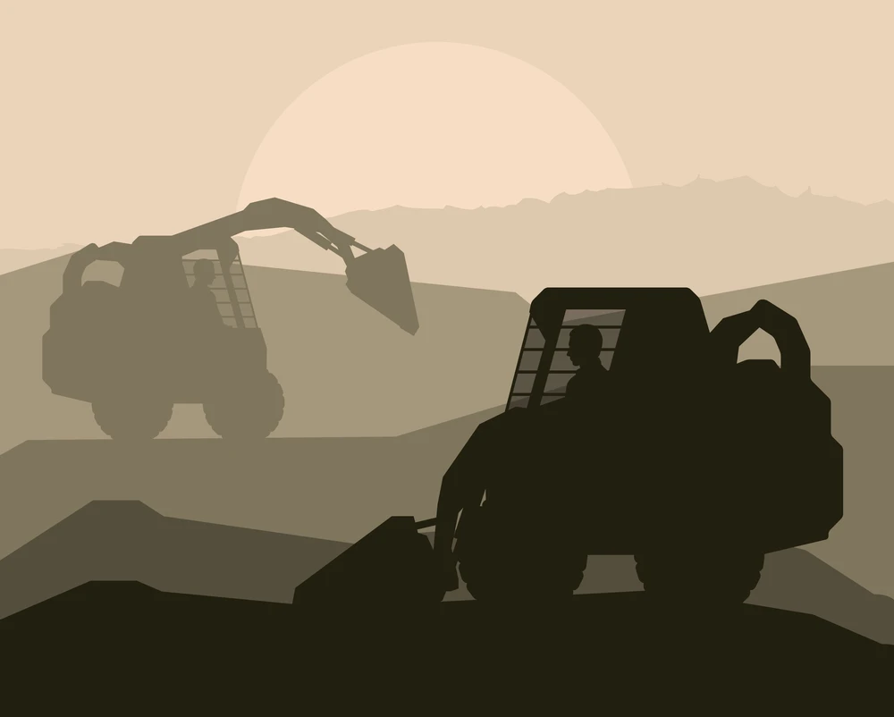 Silhouette of two demolition excavators at sunset, one lifting debris while an operator sits inside the cab.