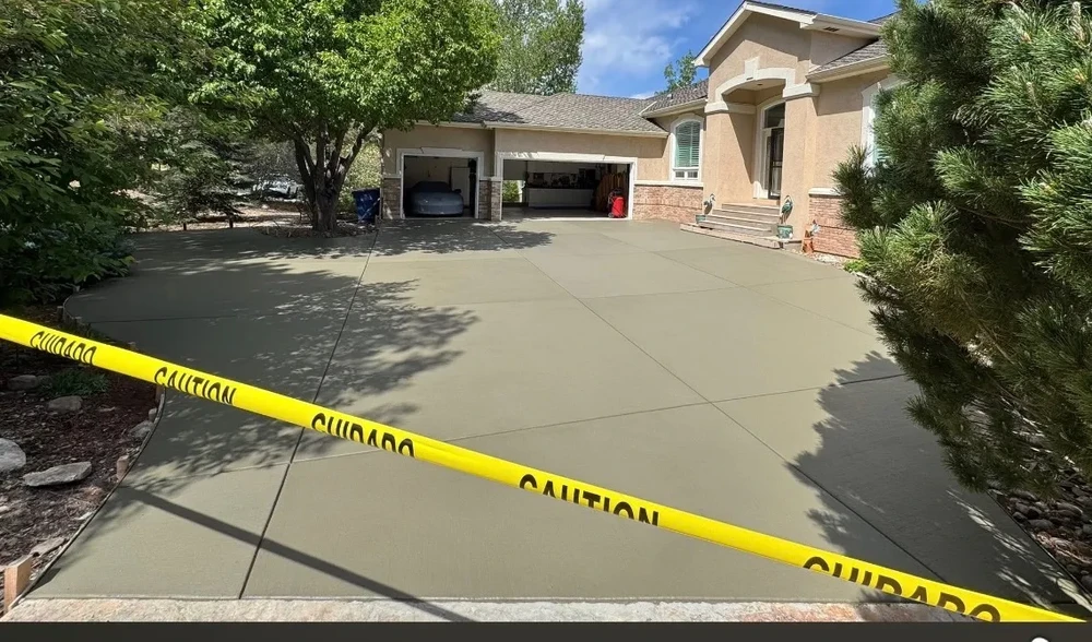 Freshly repaired driveway dries behind yellow tape marked
